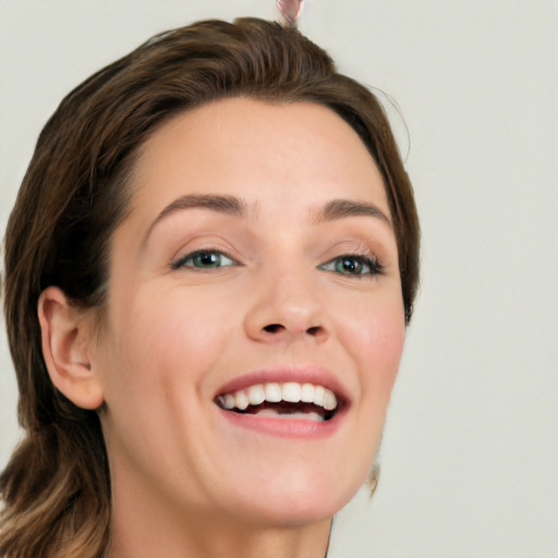 Joyful white young-adult female with long  brown hair and green eyes