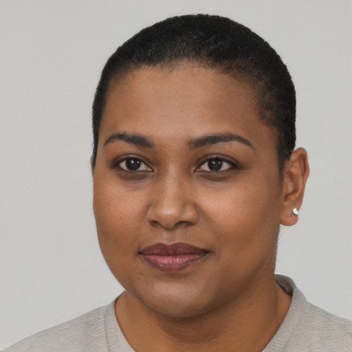 Joyful black young-adult female with short  black hair and brown eyes