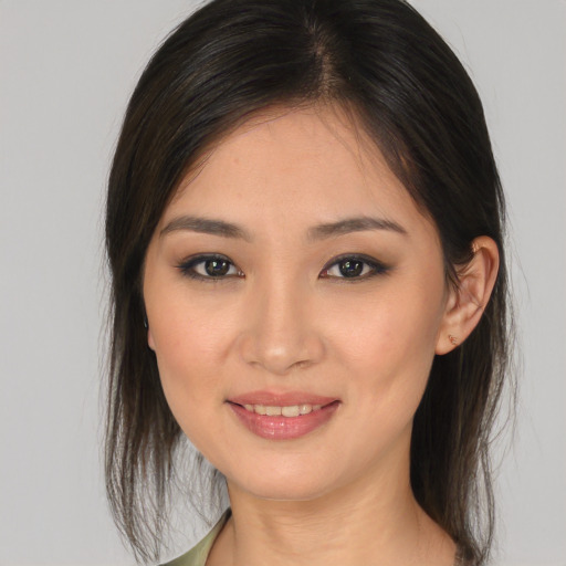 Joyful white young-adult female with medium  brown hair and brown eyes