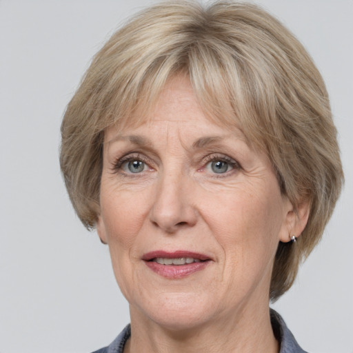 Joyful white middle-aged female with medium  brown hair and grey eyes