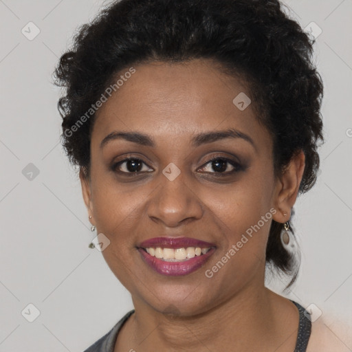 Joyful black young-adult female with short  brown hair and brown eyes