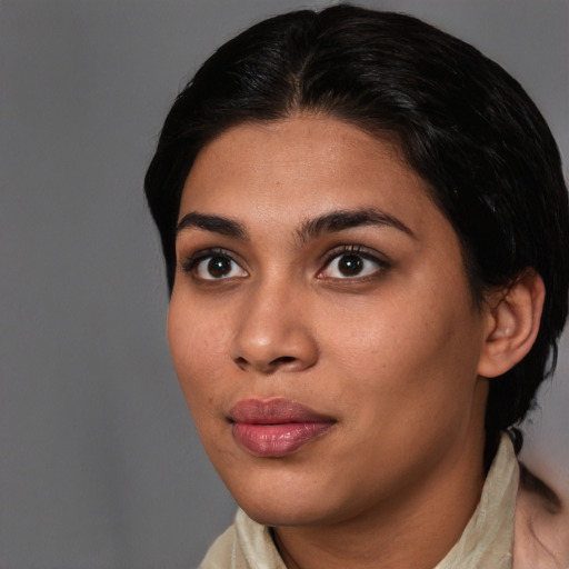 Joyful latino young-adult female with medium  brown hair and brown eyes