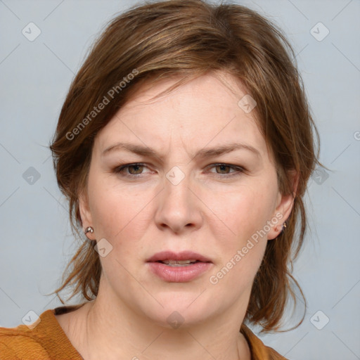 Joyful white young-adult female with medium  brown hair and blue eyes