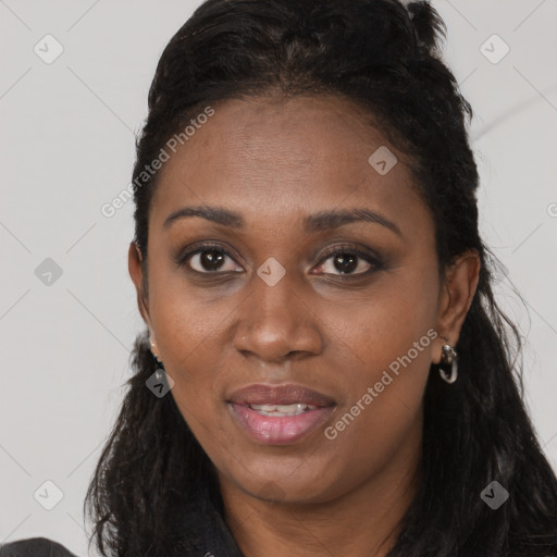 Joyful black young-adult female with long  brown hair and brown eyes