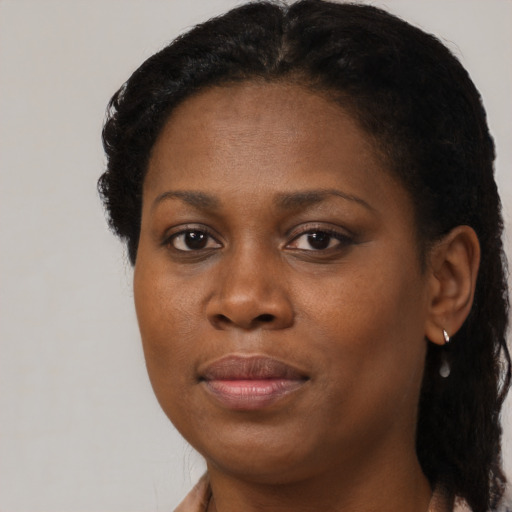 Joyful black adult female with short  brown hair and brown eyes