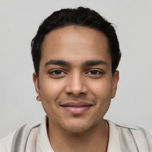 Joyful latino young-adult male with short  black hair and brown eyes