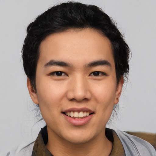 Joyful asian young-adult male with short  black hair and brown eyes