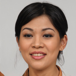 Joyful asian young-adult female with medium  brown hair and brown eyes