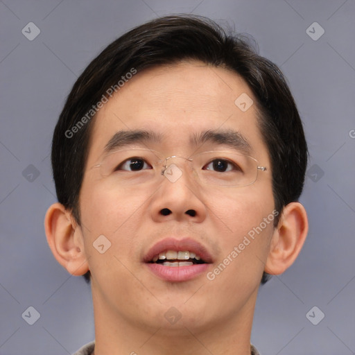 Joyful asian young-adult male with short  brown hair and brown eyes
