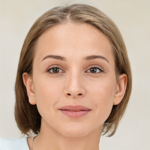 Joyful white young-adult female with medium  brown hair and green eyes