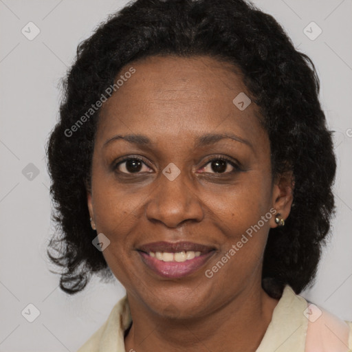 Joyful black adult female with medium  brown hair and brown eyes