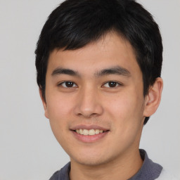 Joyful asian young-adult male with short  black hair and brown eyes