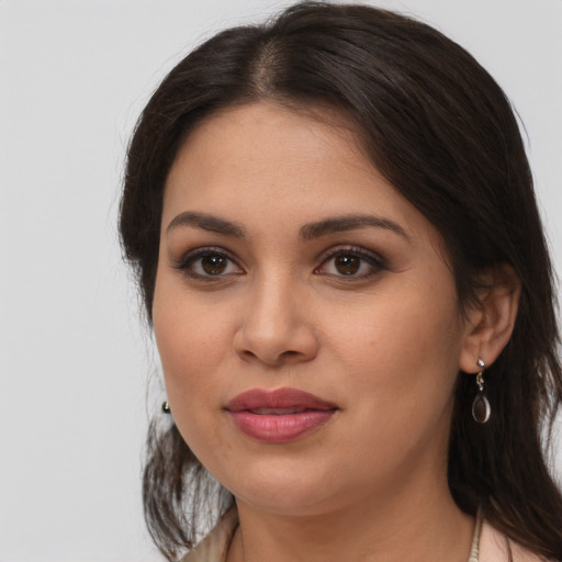 Joyful latino young-adult female with medium  brown hair and brown eyes