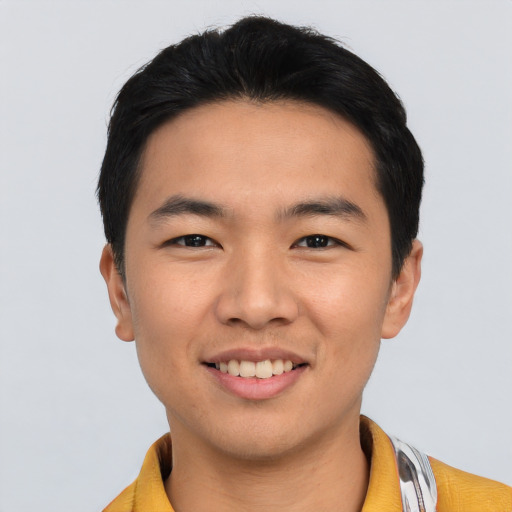 Joyful asian young-adult male with short  black hair and brown eyes