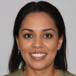 Joyful latino young-adult female with medium  brown hair and brown eyes