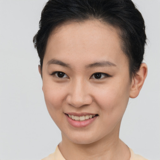 Joyful asian young-adult female with short  brown hair and brown eyes