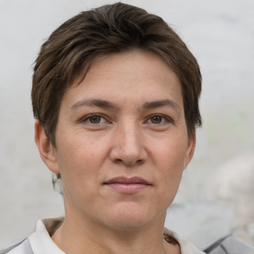 Joyful white young-adult female with short  brown hair and grey eyes