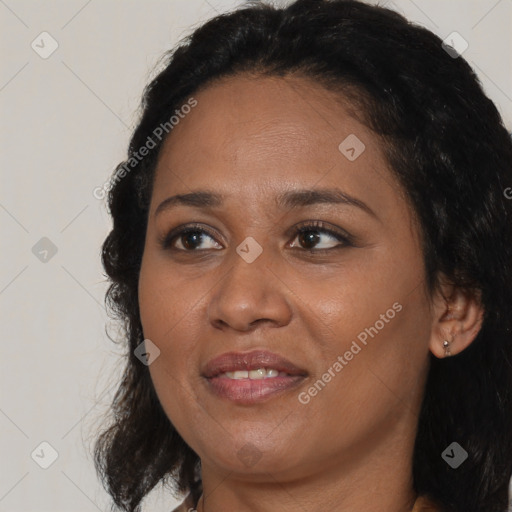 Joyful black adult female with medium  brown hair and brown eyes