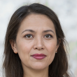 Joyful white adult female with long  brown hair and brown eyes