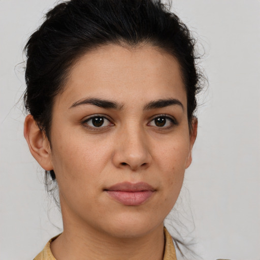 Joyful latino young-adult female with medium  brown hair and brown eyes