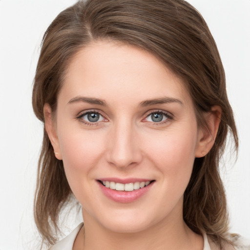 Joyful white young-adult female with medium  brown hair and grey eyes