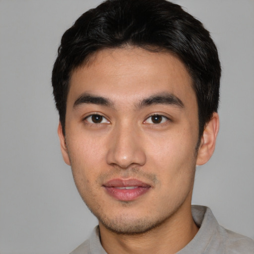 Joyful asian young-adult male with short  black hair and brown eyes