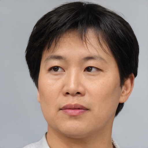 Joyful asian adult female with short  brown hair and brown eyes