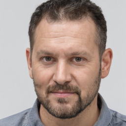 Joyful white adult male with short  brown hair and brown eyes