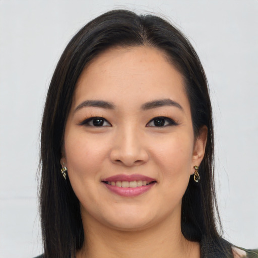 Joyful asian young-adult female with long  brown hair and brown eyes