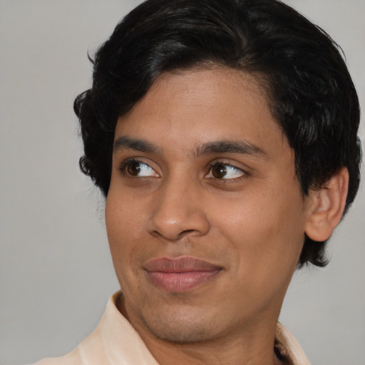 Joyful latino young-adult male with short  brown hair and brown eyes
