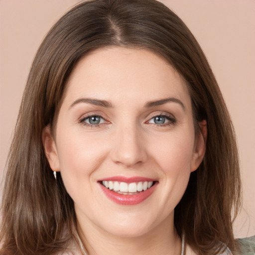 Joyful white young-adult female with medium  brown hair and grey eyes