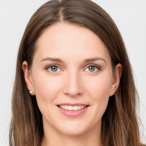 Joyful white young-adult female with long  brown hair and grey eyes