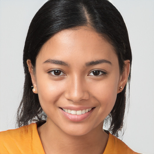 Joyful latino young-adult female with long  brown hair and brown eyes