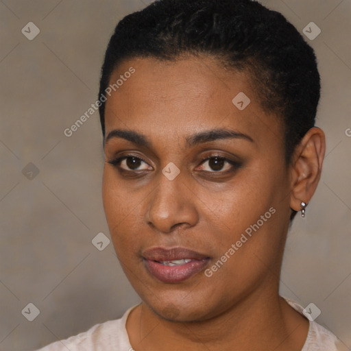 Joyful black young-adult female with short  black hair and brown eyes