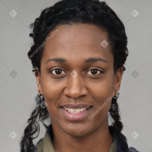 Joyful black young-adult female with long  black hair and brown eyes