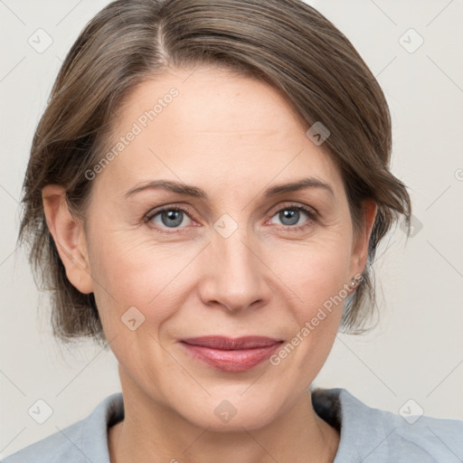 Joyful white adult female with medium  brown hair and grey eyes