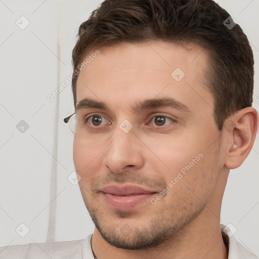 Joyful white young-adult male with short  brown hair and brown eyes