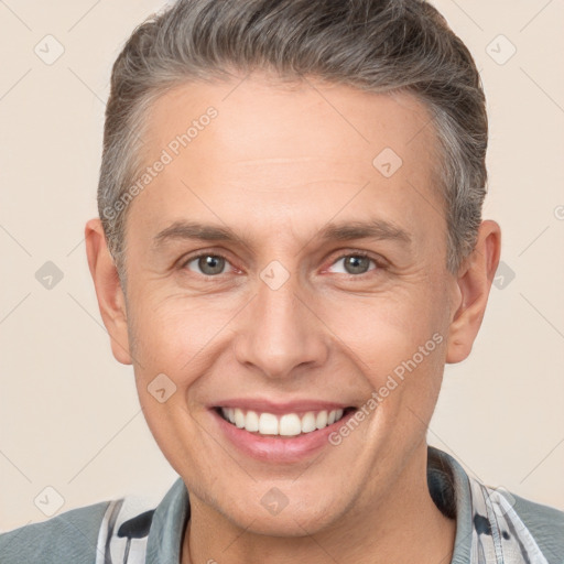 Joyful white adult male with short  brown hair and brown eyes