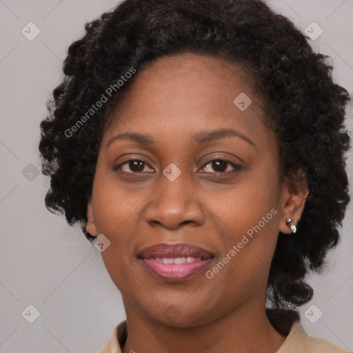 Joyful black adult female with medium  brown hair and brown eyes