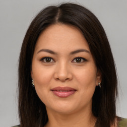 Joyful asian young-adult female with long  brown hair and brown eyes