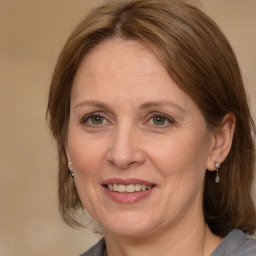 Joyful white adult female with medium  brown hair and grey eyes