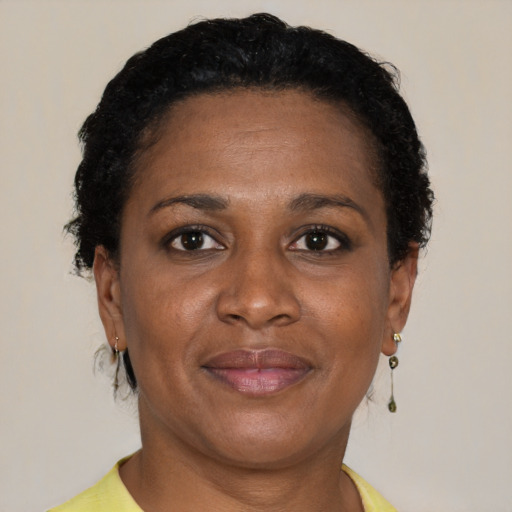 Joyful black adult female with short  brown hair and brown eyes
