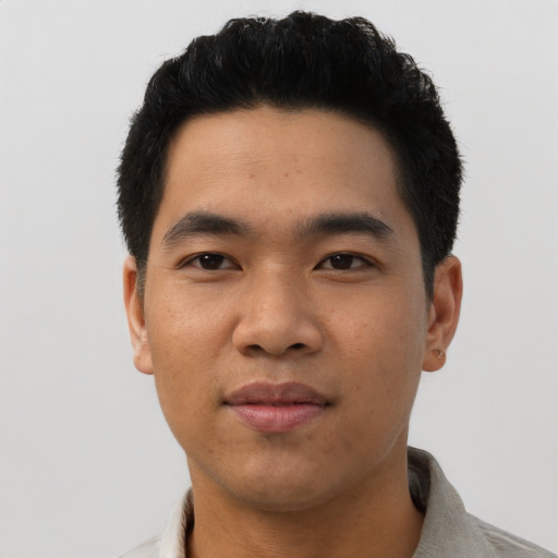 Joyful asian young-adult male with short  black hair and brown eyes