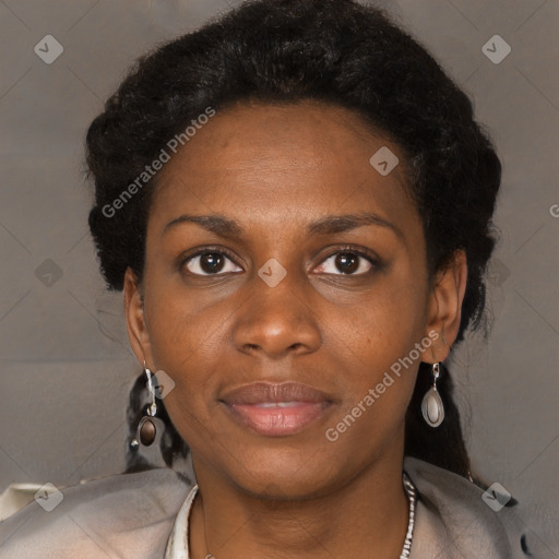 Joyful black young-adult female with long  black hair and brown eyes