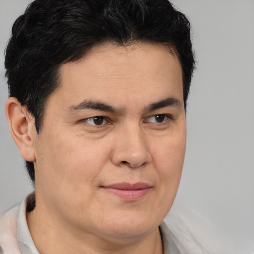 Joyful latino adult male with short  brown hair and brown eyes