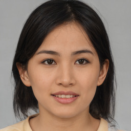 Joyful asian young-adult female with medium  brown hair and brown eyes