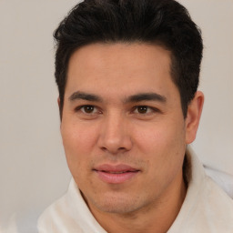 Joyful latino young-adult male with short  brown hair and brown eyes