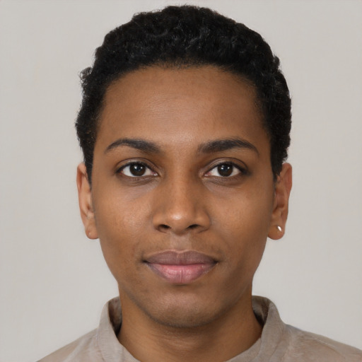 Joyful black young-adult female with short  black hair and brown eyes