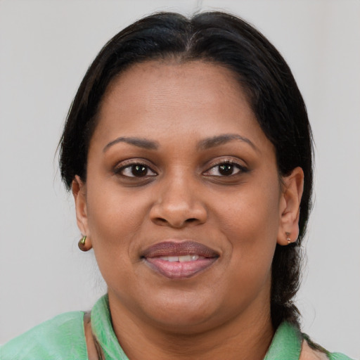 Joyful latino adult female with short  brown hair and brown eyes