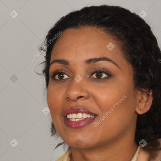 Joyful black young-adult female with long  black hair and brown eyes